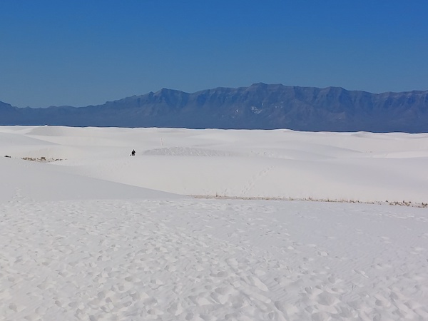 Image of white sandy dunes with a person for scale.